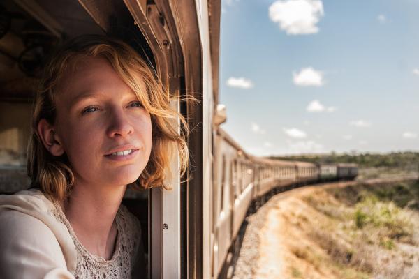 A traveller rides a train through Tanzania.